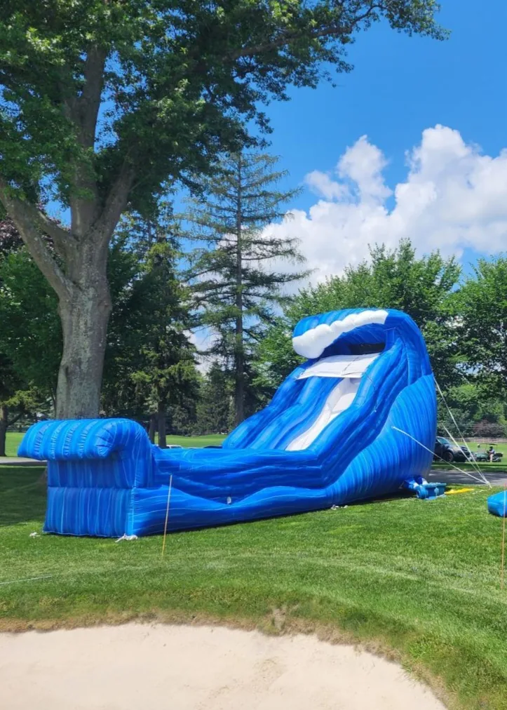 Wave-style wet water slide on grass