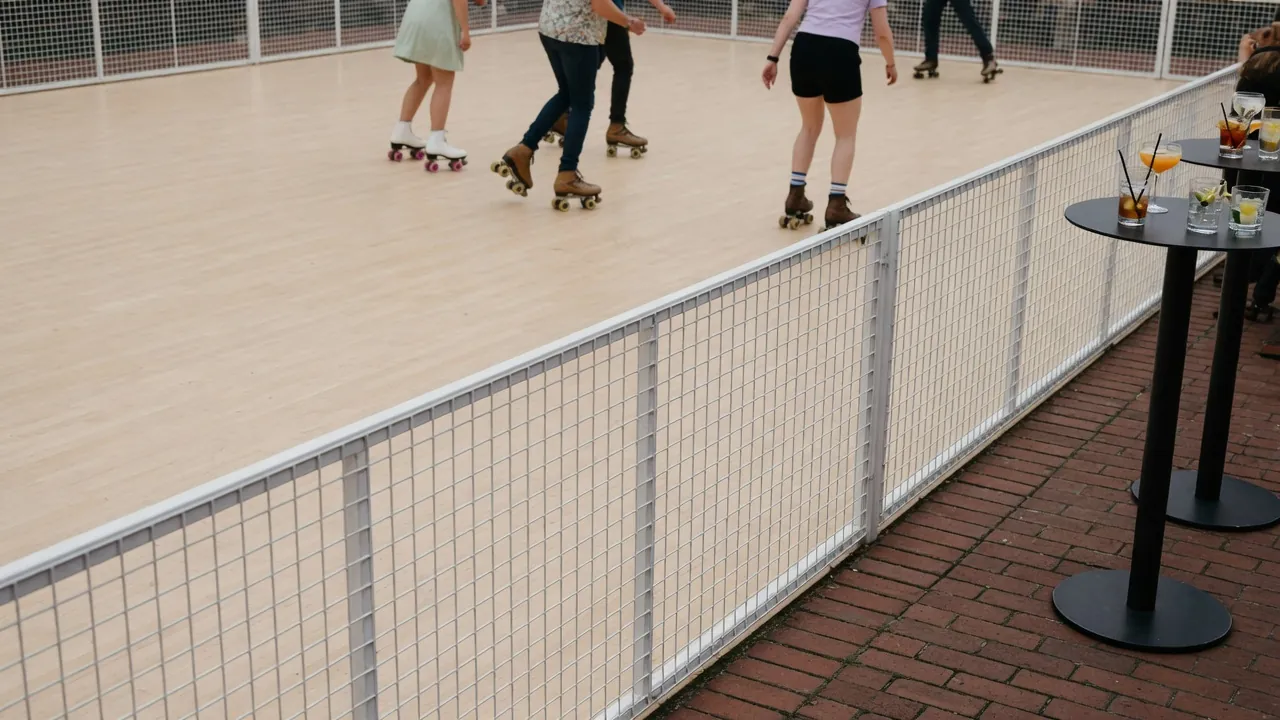 Spectators watching a managed community roller skating program