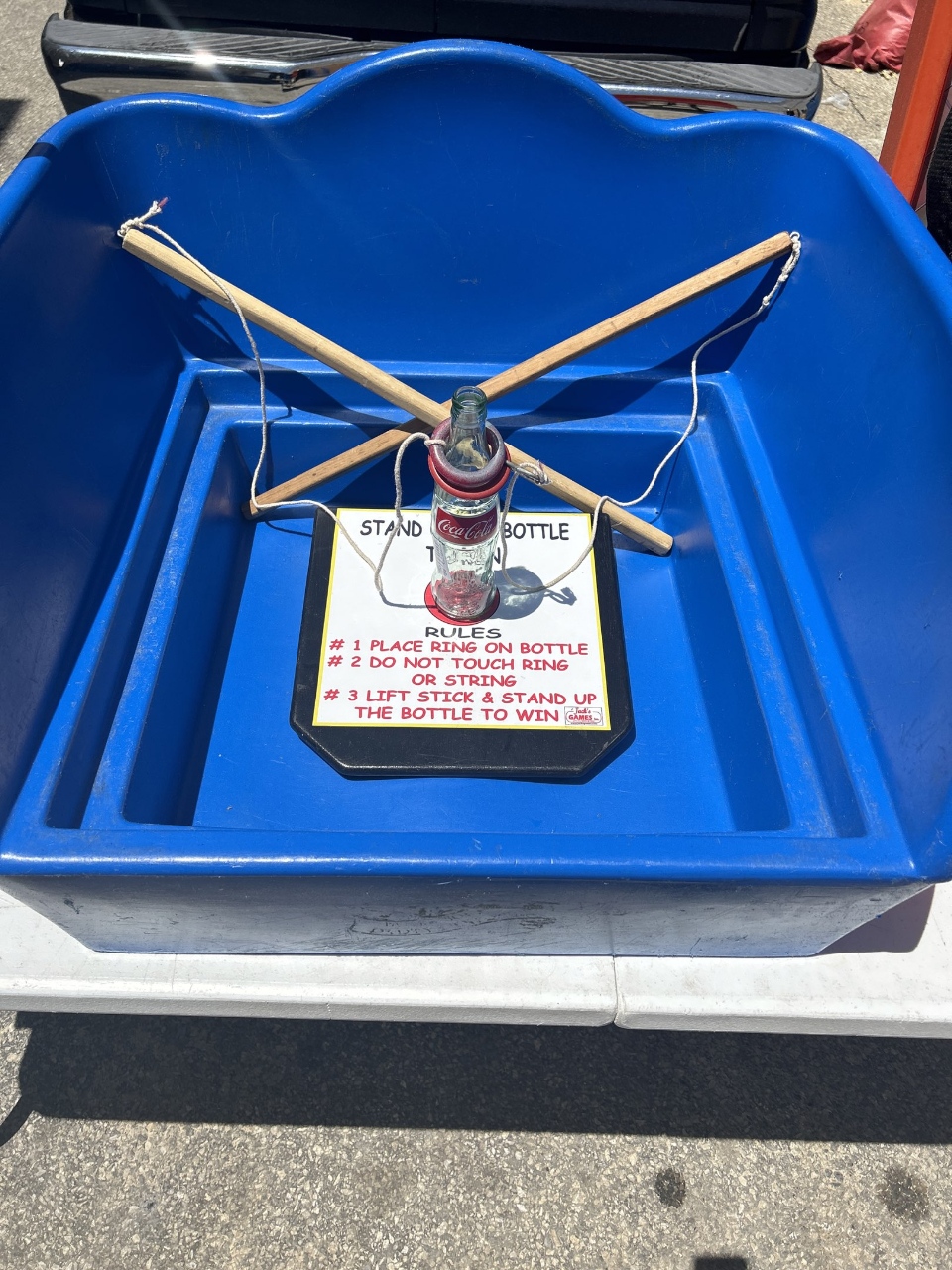 Stand It Bottle carnival game with booth and tent rental in Philadelphia PA